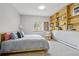Well-lit bedroom with large window, cozy bed, and built-in shelving with views of the lush, green scenery outside at 800 Highway 72, Golden, CO 80403