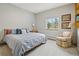 Relaxing bedroom featuring a cozy bed, soft carpet, and a bright window offering views of the surrounding trees and foliage at 800 Highway 72, Golden, CO 80403