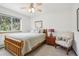 Cozy bedroom featuring a wood frame bed, natural light, and views of the wooded outdoors at 800 Highway 72, Golden, CO 80403