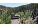 Beautiful mountain home with lots of windows and private drive nestled amongst the trees in a wooded area at 800 Highway 72, Golden, CO 80403