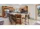 Large kitchen island with seating, stainless refrigerator, wood cabinets and modern backsplash at 800 Highway 72, Golden, CO 80403