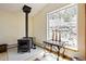 Inviting living area with a striking wood-burning stove and views from the large picture window at 800 Highway 72, Golden, CO 80403
