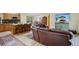 Inviting living space with kitchen view, wooden cabinets, and a comfortable seating area featuring a rustic style at 800 Highway 72, Golden, CO 80403