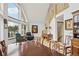 Inviting living room showcasing large windows, comfortable seating, and a staircase with log accents at 800 Highway 72, Golden, CO 80403