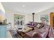 Cozy living area with a large sectional sofa, sliding glass doors to deck, and scenic views of surrounding nature at 800 Highway 72, Golden, CO 80403