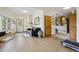 Inviting living area with tile flooring, black leather sofa, front entry and view to a bedroom, creating a cozy, welcoming space at 800 Highway 72, Golden, CO 80403