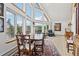 Open living area with a cozy dining area, large windows providing natural light, and scenic forest views at 800 Highway 72, Golden, CO 80403