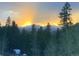 Stunning sunset view of snow-capped mountain range from the property, towering over a lush forest at 800 Highway 72, Golden, CO 80403