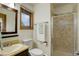 The bathroom features a glass-door shower and modern fixtures with a window at 31150 Manitoba Dr, Evergreen, CO 80439