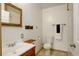 Bathroom featuring a wood vanity, natural wood framed mirror and tiled floors at 31150 Manitoba Dr, Evergreen, CO 80439