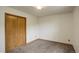 Bedroom boasts carpet, a standard closet, neutral colored walls, and natural light window at 31150 Manitoba Dr, Evergreen, CO 80439