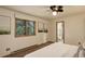 Carpeted bedroom with a natural light window with a view and bathroom access at 31150 Manitoba Dr, Evergreen, CO 80439