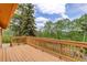 Spacious wooden deck surrounded by lush greenery at 31150 Manitoba Dr, Evergreen, CO 80439