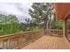 Spacious wooden deck surrounded by lush greenery at 31150 Manitoba Dr, Evergreen, CO 80439