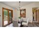 Dining room featuring deck access, a painting, and wood flooring at 31150 Manitoba Dr, Evergreen, CO 80439