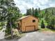 Side exterior featuring a garage and deck with stairs at 31150 Manitoba Dr, Evergreen, CO 80439
