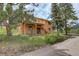 Charming home with a rear patio, wood siding, and access to the outdoors via stairs at 31150 Manitoba Dr, Evergreen, CO 80439