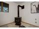 Close up of modern fireplace with a black finish next to a window and cow art at 31150 Manitoba Dr, Evergreen, CO 80439
