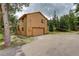 View of exterior featuring garage and deck with outdoor staircase at 31150 Manitoba Dr, Evergreen, CO 80439