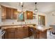 Kitchen showcasing oak cabinets, a tile countertop, stainless steel appliances and a large window at 31150 Manitoba Dr, Evergreen, CO 80439
