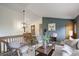 Open living room features a rustic wood staircase and a modern color palette at 31150 Manitoba Dr, Evergreen, CO 80439