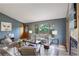 Bright living room with stylish decor, wood floors, and large windows at 31150 Manitoba Dr, Evergreen, CO 80439