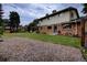 Exterior showcasing a well-maintained two-story home with a brick foundation and manicured backyard at 10373 W 75Th Ave, Arvada, CO 80005