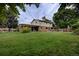 Expansive backyard view of a well-kept lawn, covered patio, and home exterior at 10373 W 75Th Ave, Arvada, CO 80005