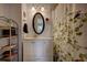 Bathroom featuring oval mirror and botanical shower curtain that adds a refreshing touch at 10373 W 75Th Ave, Arvada, CO 80005