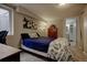 Bedroom featuring soft carpeting, a full sized bed and a glimpse into an ensuite bathroom at 10373 W 75Th Ave, Arvada, CO 80005