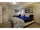 Cozy bedroom with a comfortable bed, complemented by serene artwork and a functional desk area at 10373 W 75Th Ave, Arvada, CO 80005