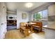 Charming breakfast nook features a built-in bench, wooden table, and natural light from a large window at 10373 W 75Th Ave, Arvada, CO 80005