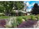 Beautifully landscaped front yard with a large shade tree and brick accents on this two-story home at 10373 W 75Th Ave, Arvada, CO 80005