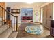 Inviting foyer features wood floors, a staircase, and an open view into the adjacent living room at 10373 W 75Th Ave, Arvada, CO 80005