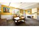 Comfortable living room boasts a brick fireplace, bright yellow walls, and cozy seating at 10373 W 75Th Ave, Arvada, CO 80005