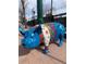 A colorful, decorated pig statue is displayed on a brick walkway with hanging lights at 10373 W 75Th Ave, Arvada, CO 80005