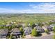 Aerial view of neighborhood with green spaces, homes and mountain views at 1513 Cannon Mountain Dr, Longmont, CO 80503