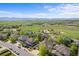 Beautiful aerial view of a neighborhood with lush green spaces, mature trees, and mountain views in the distance at 1513 Cannon Mountain Dr, Longmont, CO 80503