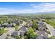 Aerial view of a residential neighborhood with manicured lawns, mature trees and mountain backdrop at 1513 Cannon Mountain Dr, Longmont, CO 80503
