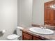 Cozy bathroom features a wood door and granite countertops over the vanity at 1513 Cannon Mountain Dr, Longmont, CO 80503