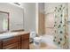 Well-lit bathroom featuring a shower over tub, linen closet and vanity at 1513 Cannon Mountain Dr, Longmont, CO 80503