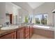 Luxurious bathroom featuring dual sinks, a large mirror, a soaking tub, and a separate shower at 1513 Cannon Mountain Dr, Longmont, CO 80503