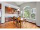 Inviting dining area with hardwood floors, a wooden table, and bright, sunlit windows at 1513 Cannon Mountain Dr, Longmont, CO 80503