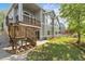 Rear exterior view of home with lush lawn and balcony, stairs and walkout basement at 1513 Cannon Mountain Dr, Longmont, CO 80503