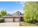 Beautiful brick two-story home featuring a two-car garage and well-manicured front yard at 1513 Cannon Mountain Dr, Longmont, CO 80503