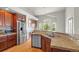 Well-appointed kitchen featuring granite countertops, stainless steel appliances, and wood cabinets at 1513 Cannon Mountain Dr, Longmont, CO 80503