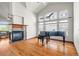 Bright living room featuring hardwood floors, a fireplace, high ceilings, and a piano at 1513 Cannon Mountain Dr, Longmont, CO 80503