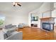 Open living room with hardwood floors, fireplace, large windows, and cozy seating at 1513 Cannon Mountain Dr, Longmont, CO 80503