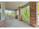 Inviting covered porch with brick columns and wrought iron railing, perfect for relaxing outdoors at 1513 Cannon Mountain Dr, Longmont, CO 80503