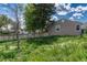 A cozy backyard offers a tranquil outdoor space with a wooden fence and lush green foliage at 7301 Dale Ct, Westminster, CO 80030